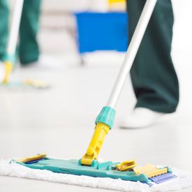 Two woman cleaning the floor of a commercial property